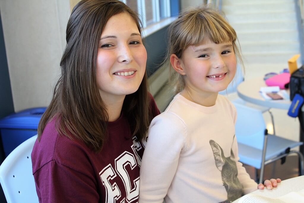 mother and daughter smiling at camera