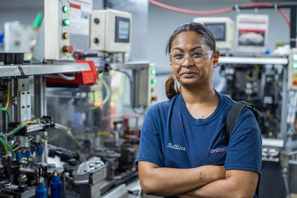 Bettina standing in front of machinary