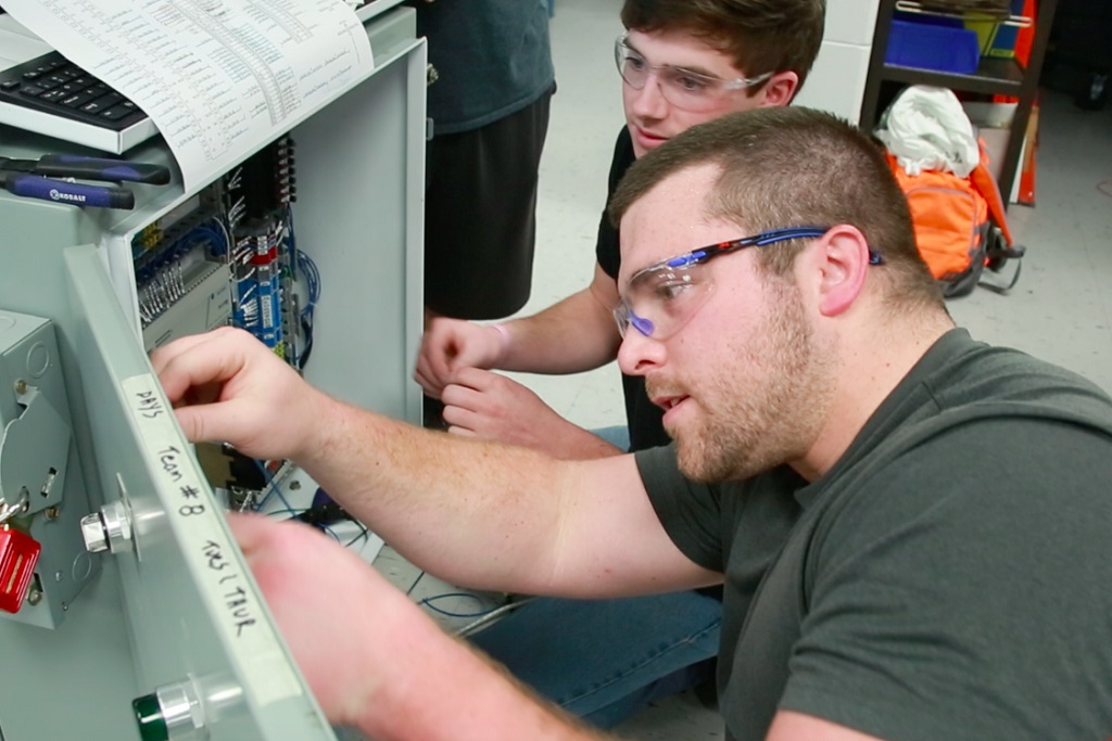two guys working on machine